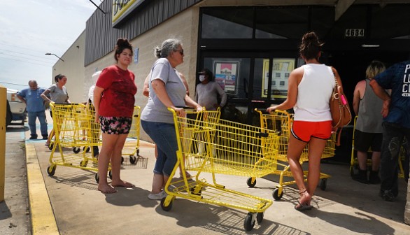 People wait in line to buy supplies in Louisiana 