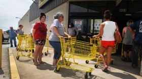 People wait in line to buy supplies in Louisiana 