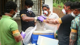 Animal Husbandry department and Forest officials deposit a bat into a container after catching it inside a well 