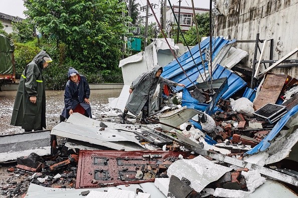 Rescuers clean up debris after an earthquake that killed three and injured a dozen in Luzhou