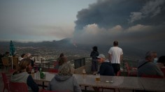 People watching the Cumbre Vieja volcano spews lava, ash and smoke