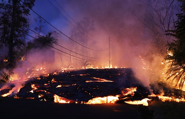 Lava from a Kilauea volcano fissure advances up a residential street 
