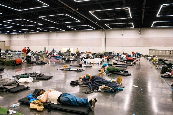 People rest at a cooling station due to heat wave
