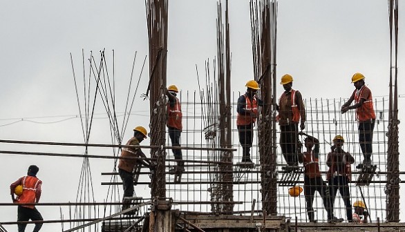 Laborers work at a construction site 