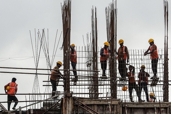 Laborers work at a construction site 
