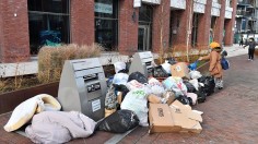 Bags of rubbish piled around uncollected waste bins