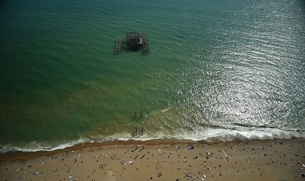 Beachgoers relax by the sea during a heatwave 