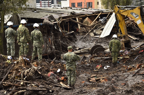 Backhoe digger searching for victims amid mud in La Gasca neighborhood, northern Quito.