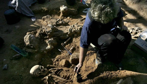 An Israeli archeologist excavates an ancient Roman cemetery