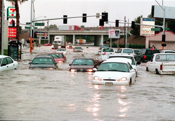 Motorists try to cross flood waters at the interse