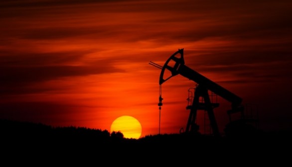 Pump-jack mining crude oil with the sunset