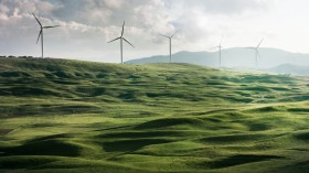 wind turbine surrounded by grass 