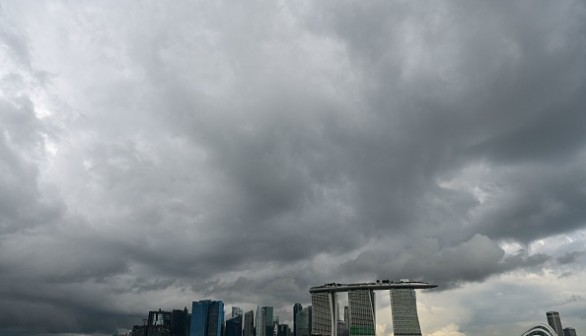 Rain clouds are pictured over the city skyline in Singapore on June 21, 2022.
