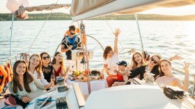 A Group of People Riding a Yacht while Having a Party