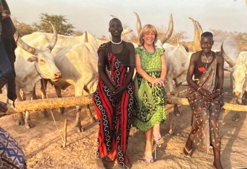 Ranching out: Franci Neely posed with Mundari people at the Mundari cattle camp near Juba, South Sudan, on Feb. 19, 2022