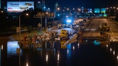 City workers pump water off a portion of Interstate 676 after flooding from heavy rains from hurricane Ida in Philadelphia, Pennsylvania on September 2, 2021 