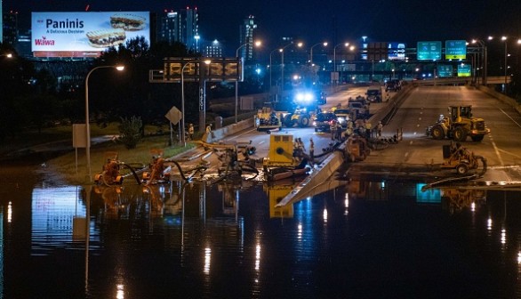 City workers pump water off a portion of Interstate 676 after flooding from heavy rains from hurricane Ida in Philadelphia, Pennsylvania on September 2, 2021 