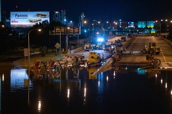 City workers pump water off a portion of Interstate 676 after flooding from heavy rains from hurricane Ida in Philadelphia, Pennsylvania on September 2, 2021 
