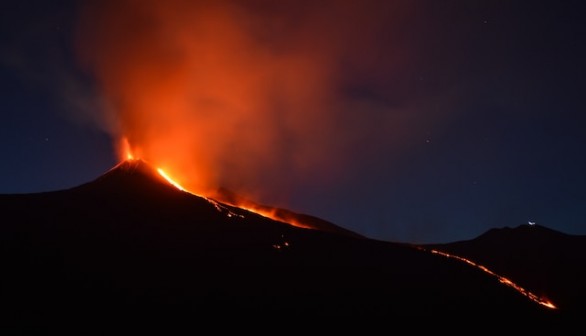 Black Mountain with flowing lava at nightime