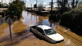 A vehicle remains on a flooded street after heavy rains in Santa Cruz, Chile on August 23, 2023.