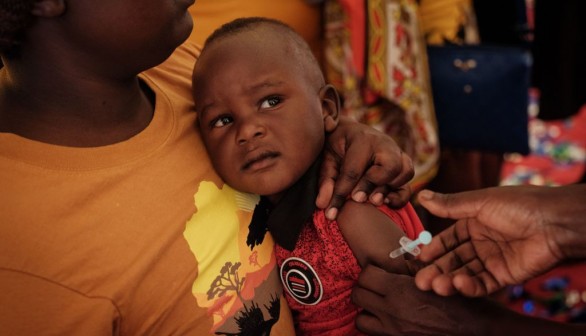 child receiving malaria shot in Kenya