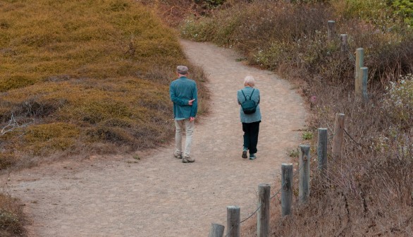 A Couple Walking on Dirt Road
