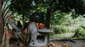 Cooking On A Black Pot Using Firewood