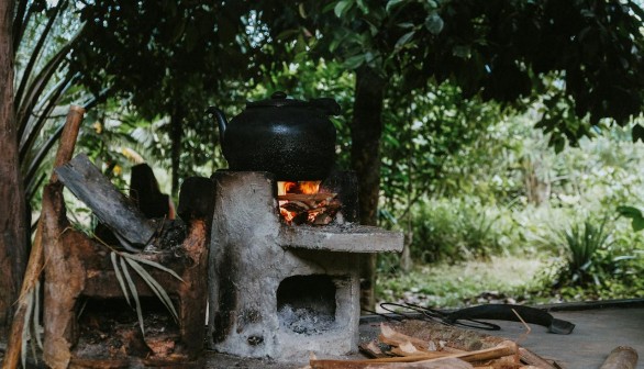 Cooking On A Black Pot Using Firewood