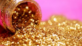 A close up macro shot of a bottle of fabulous gold glitter!