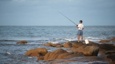 A stock photo of a man fishing.