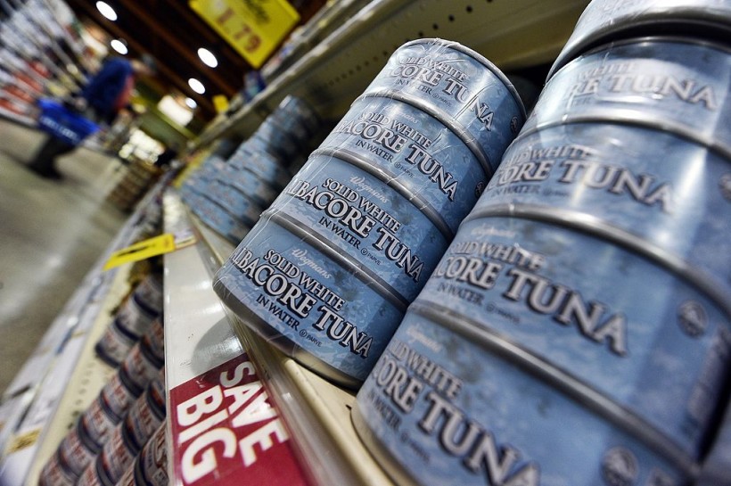 Canned tuna are pictured as a man shops