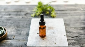 brown glass bottle on brown wooden table