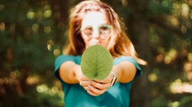 woman holding leaf