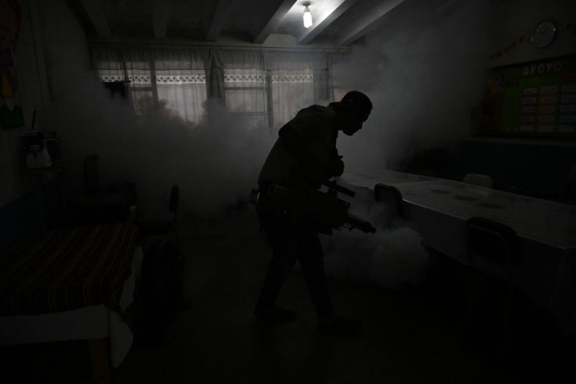 man spraying insecticide against mosquitoes 