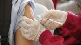 a student being injected with a vaccine