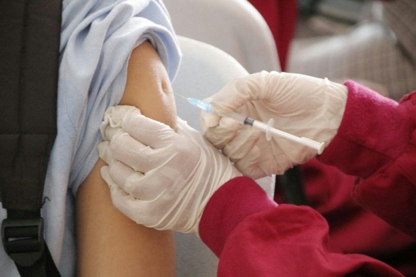 a student being injected with a vaccine