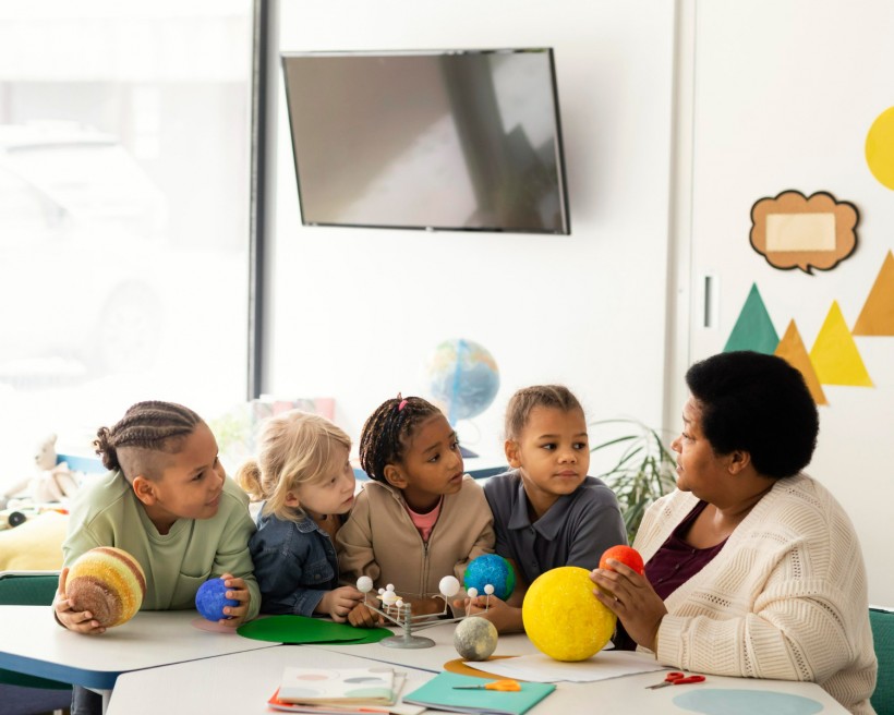 Woman teaching kids