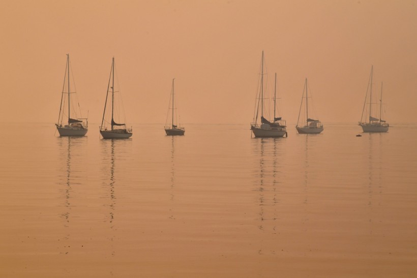 Heavy smoke shrouds yachts moored at Batemans Bay, New South Wales, Australia