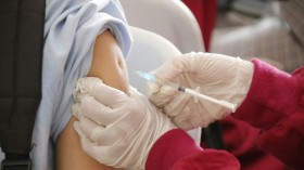 a student being injected with a vaccine